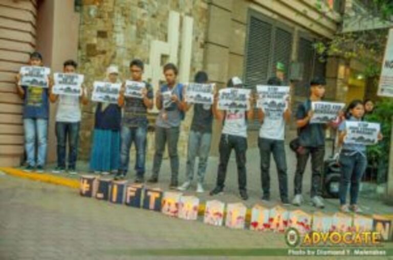 Kalinaw holds candle-lighting protest outside FEU